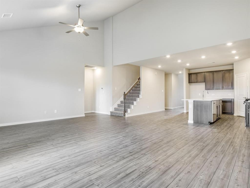2256 Bellatrix Drive Haslet, TX 76052 - Photo 4 of 24 a view of an empty room with wooden floor kitchen view and a window