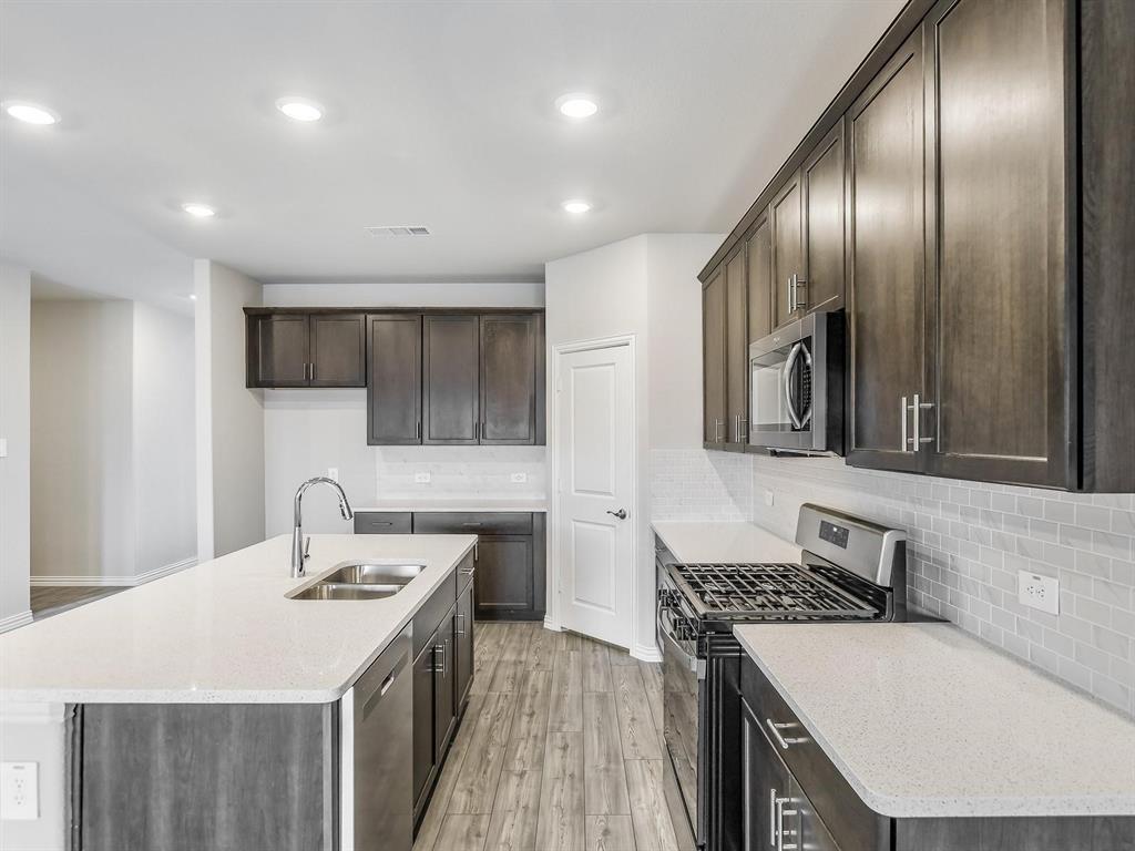 2256 Bellatrix Drive Haslet, TX 76052 - Photo 5 of 24 a kitchen with a sink stove and cabinets