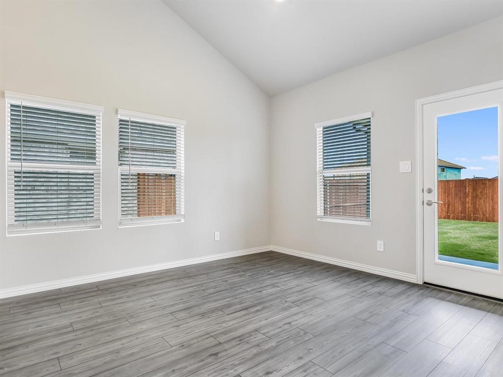 2256 Bellatrix Drive Haslet, TX 76052 - Photo 8 of 24 a view of an empty room with wooden floor and a window
