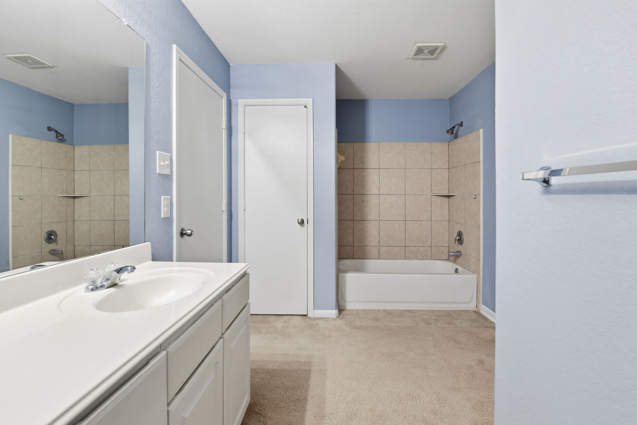 16763 North Blue Jay Drive Conroe, TX 77385 - Photo 16 of 26 a bathroom with a bathtub shower sink vanity and a mirror