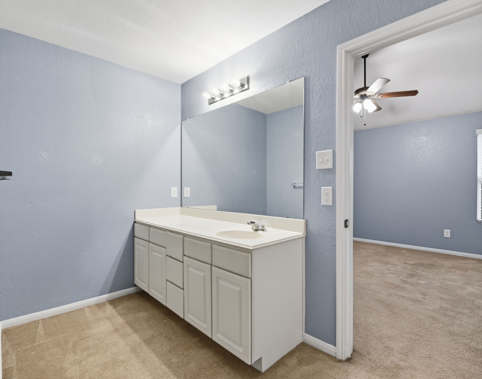 16763 North Blue Jay Drive Conroe, TX 77385 - Photo 17 of 26 a bathroom with a sink a mirror and vanity