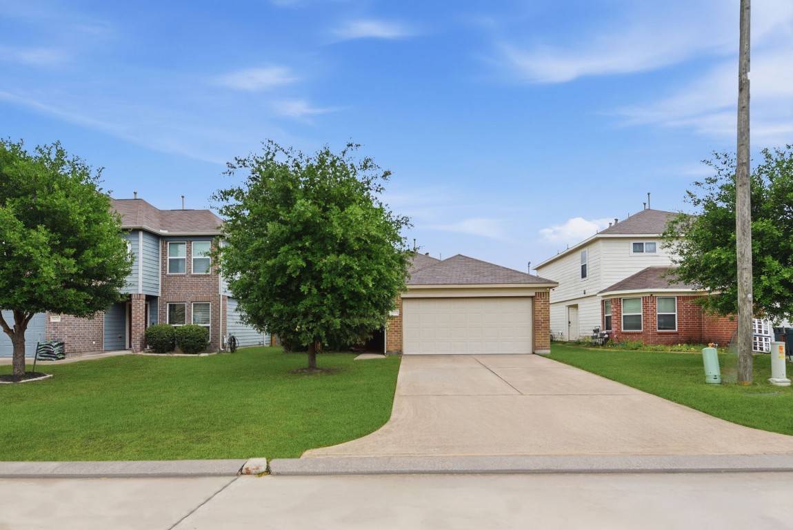 16763 North Blue Jay Drive Conroe, TX 77385 - Photo 2 of 26 front view of house with a yard
