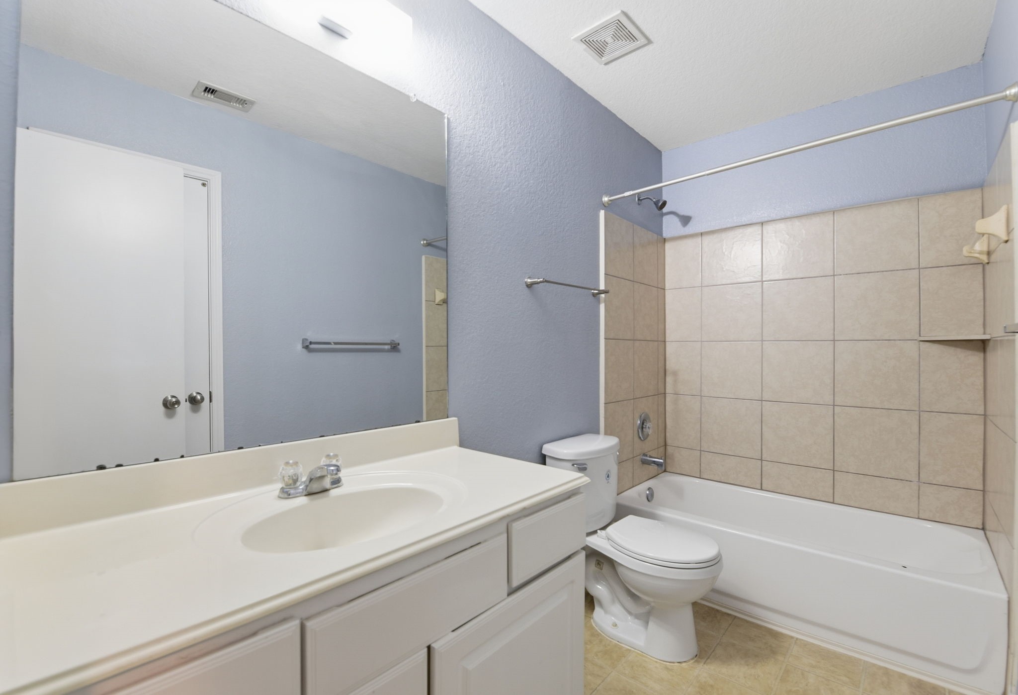 16763 North Blue Jay Drive Conroe, TX 77385 - Photo 21 of 26 a bathroom with a sink a toilet and shower
