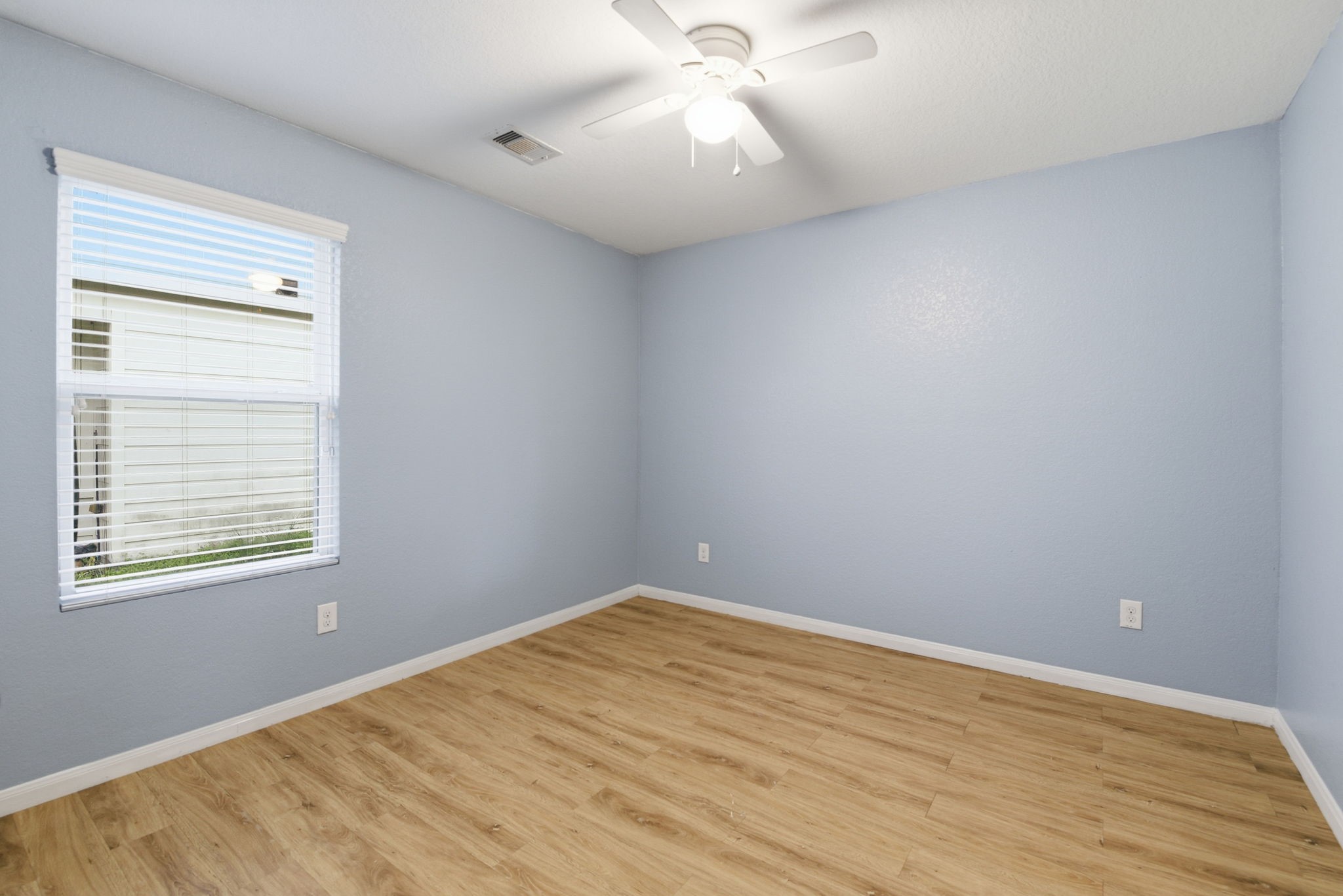 16763 North Blue Jay Drive Conroe, TX 77385 - Photo 23 of 26 a view of an empty room with wooden floor and a window