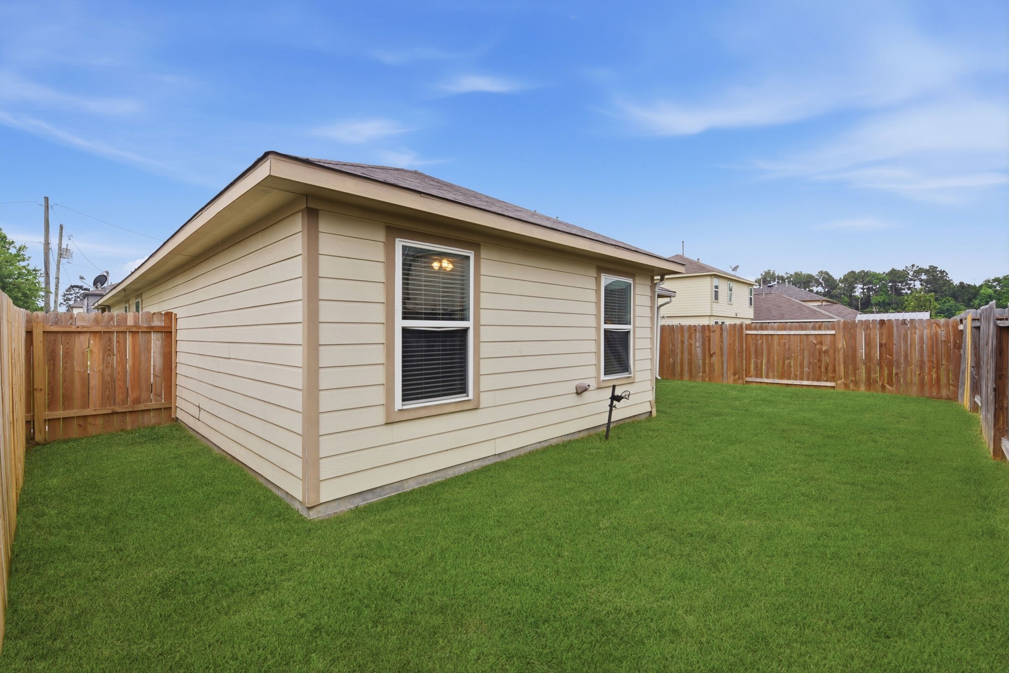 16763 North Blue Jay Drive Conroe, TX 77385 - Photo 24 of 26 a view of a house with a backyard