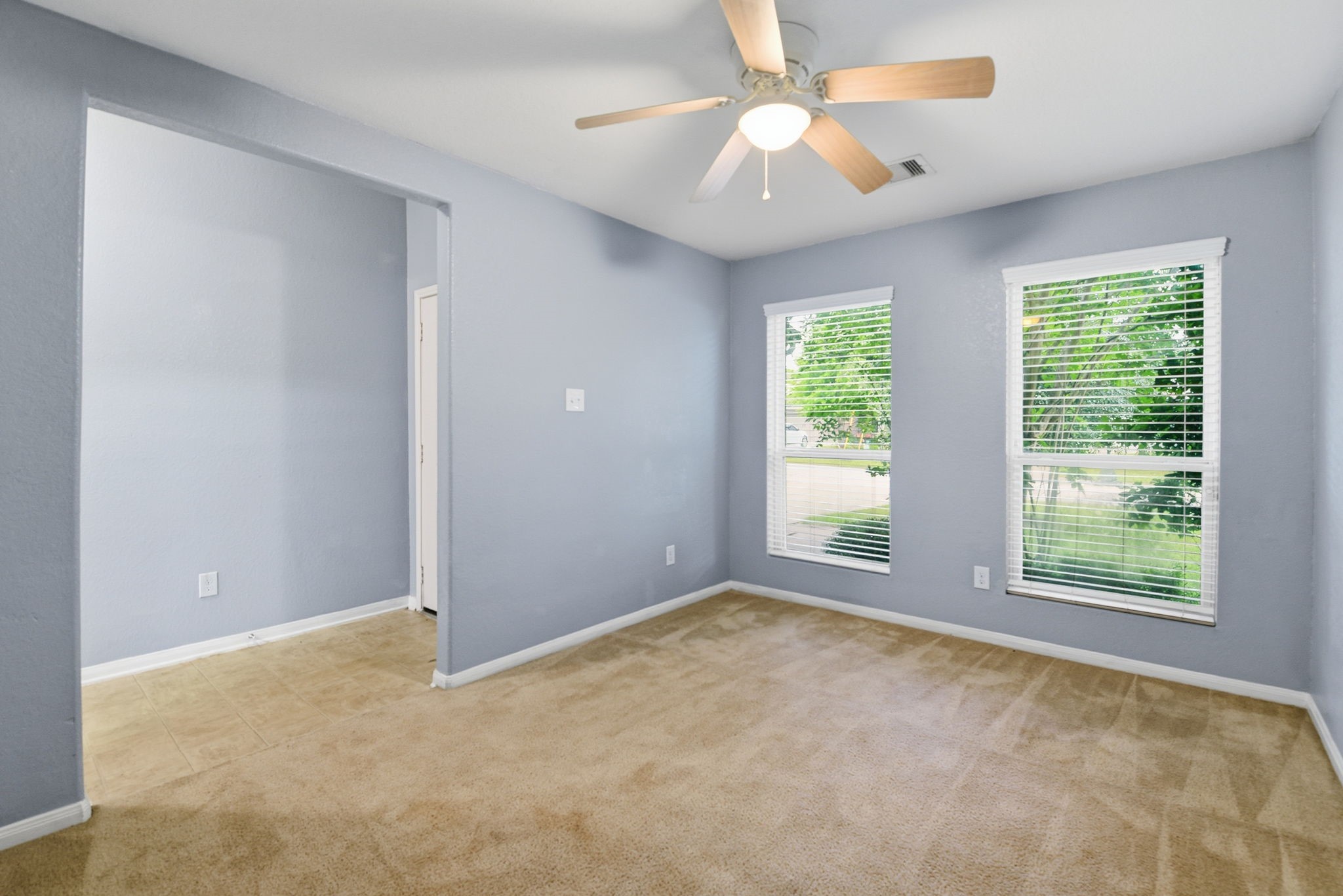 16763 North Blue Jay Drive Conroe, TX 77385 - Photo 5 of 26 an empty room with windows and fan