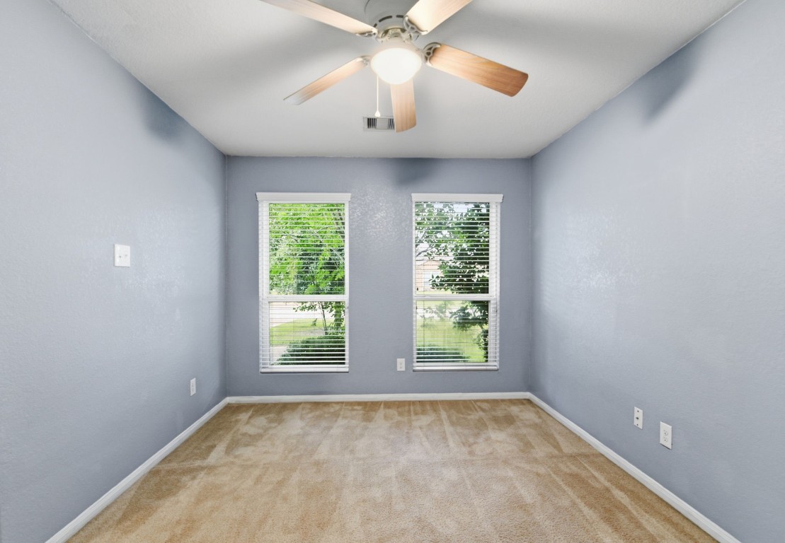 16763 North Blue Jay Drive Conroe, TX 77385 - Photo 6 of 26 an empty room with windows and chandelier fan