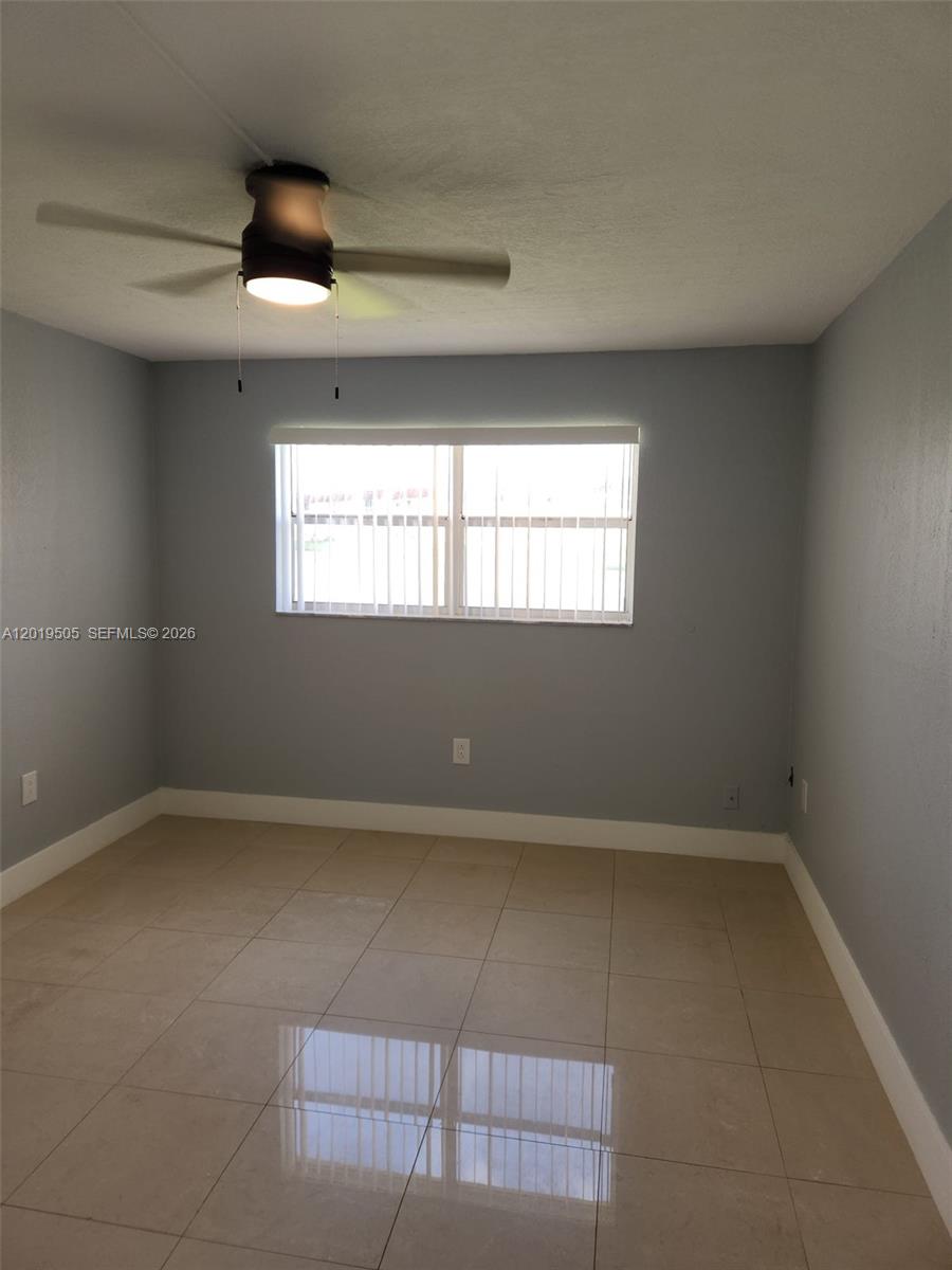 2811 North Pine Island Road, Unit 107 Sunrise, FL 33322 - Photo 12 of 16 an empty room with windows