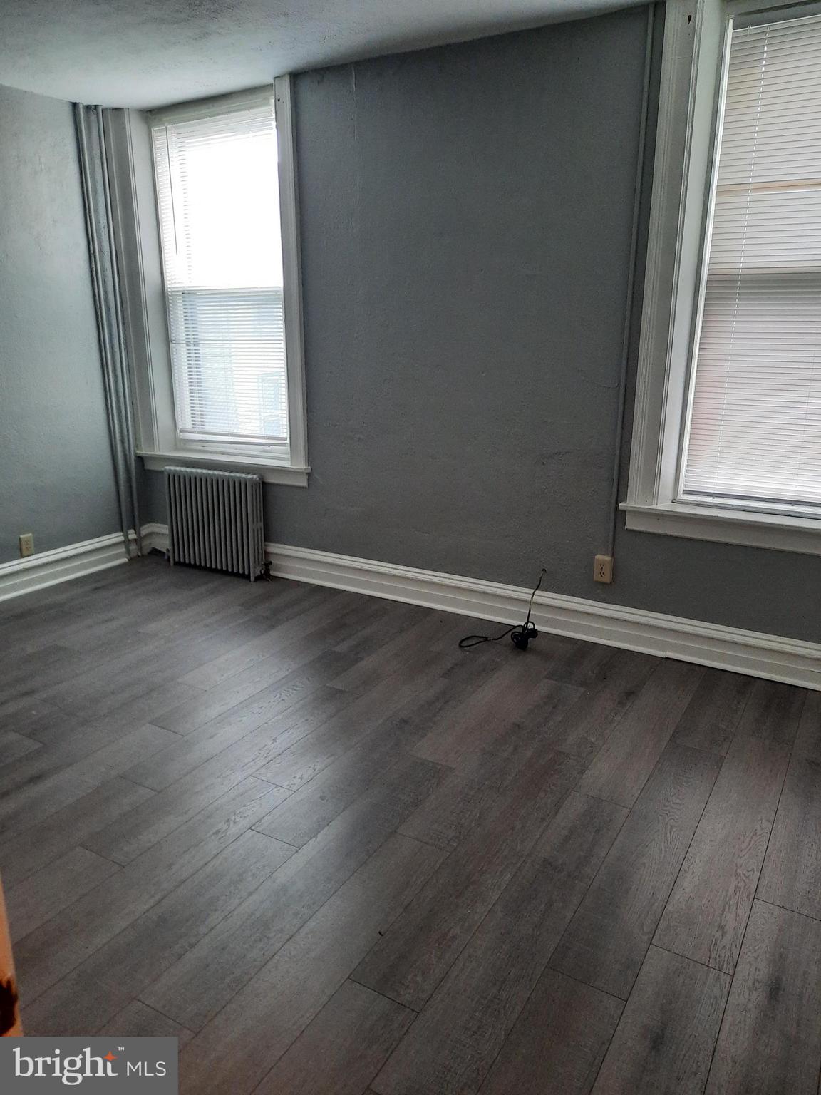 12 South Filbert Street, Unit B6 Mechanicsburg, PA 17055 - Photo 3 of 5 an empty room with wooden floor and windows