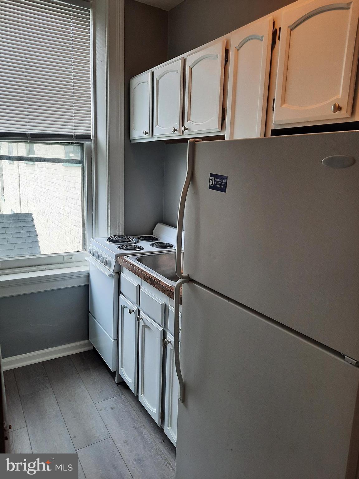 12 South Filbert Street, Unit B6 Mechanicsburg, PA 17055 - Photo 5 of 5 a kitchen with a refrigerator and white cabinets