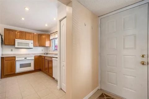 a kitchen with a refrigerator a sink and a stove top oven