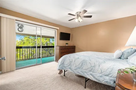 a bedroom with a bed and a flat tv screen