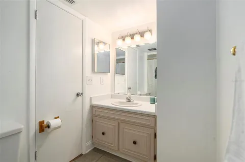a bathroom with a double vanity sink mirror and