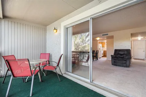 a dining room with furniture and large windows