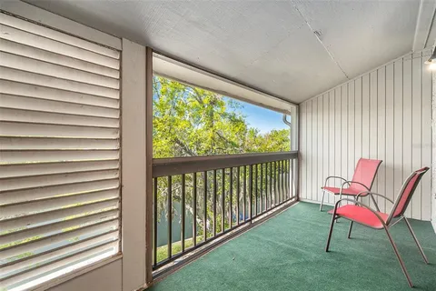a view of a room with furniture and a window