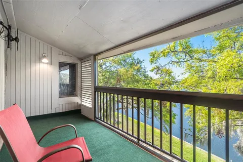 a living room with furniture a flat screen tv and a window