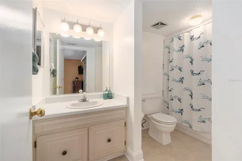 a bed sitting in a spacious bedroom next to a window