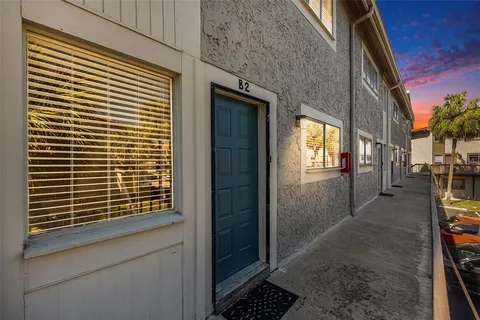 a view of a room that has wooden door and a window