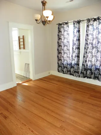 an empty room with wooden floor and closet