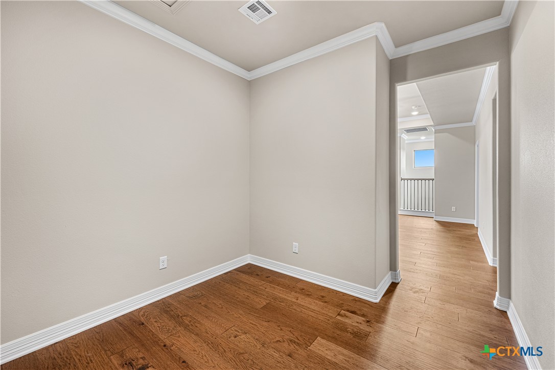 2136 Oak Draw Court Belton, TX 76513 - Photo 25 of 46 an empty room with wooden floor and windows