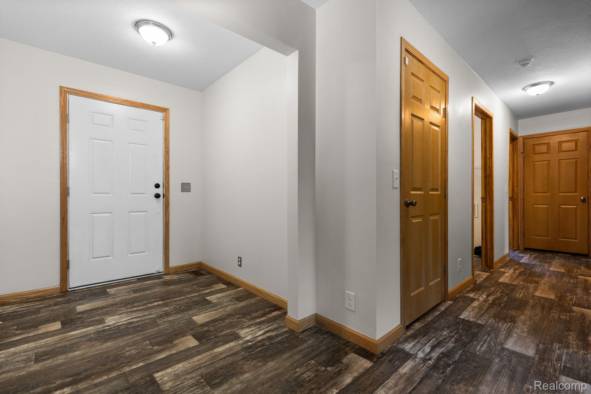 102 Wiard Road Ypsilanti, MI 48198 - Photo 7 of 37 Foyer entrance featuring dark wood finished floors and baseboards