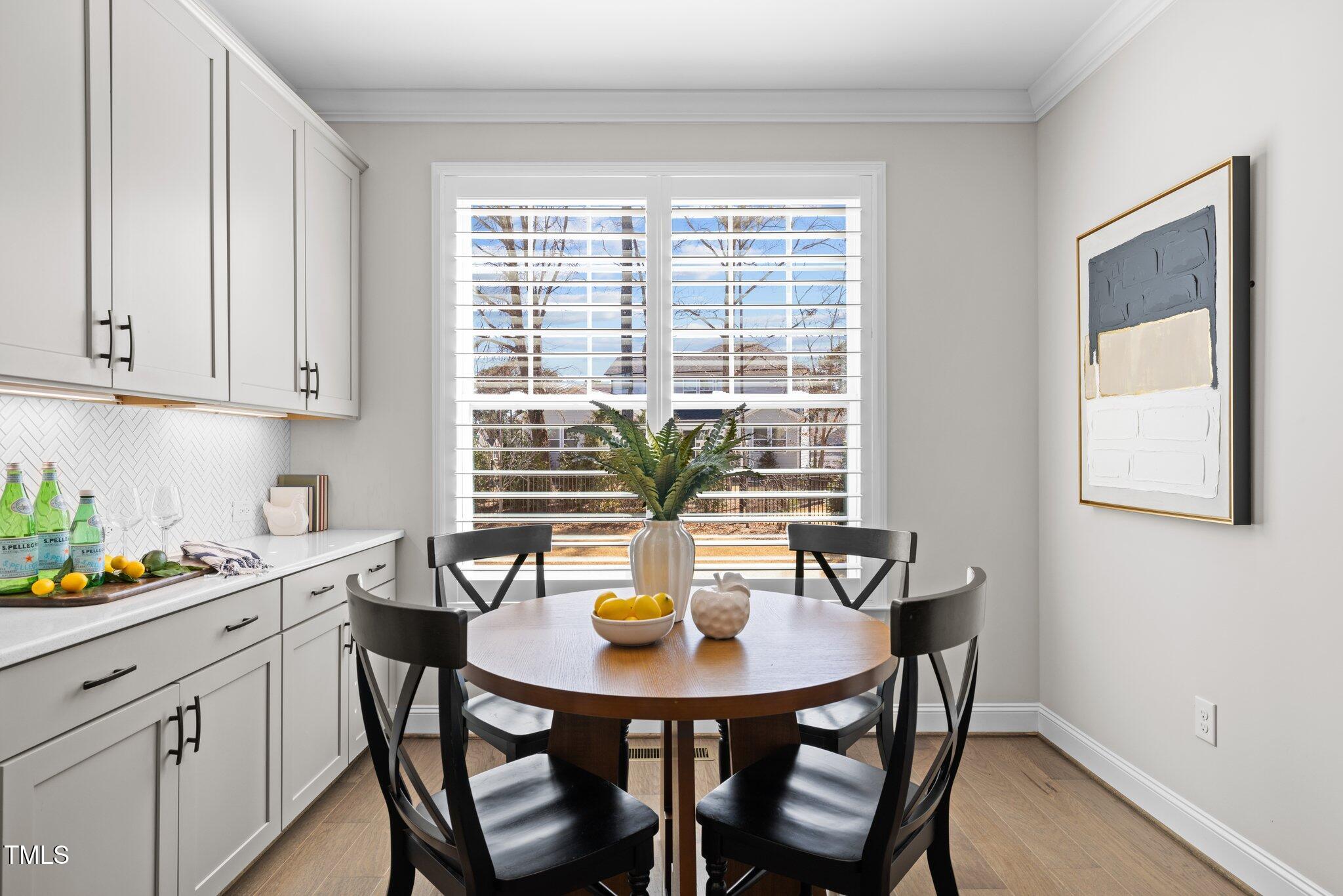 1013 Manchaca Loop Apex, NC 27539 - Photo 11 of 50 a view of a dining room with a table and chairs