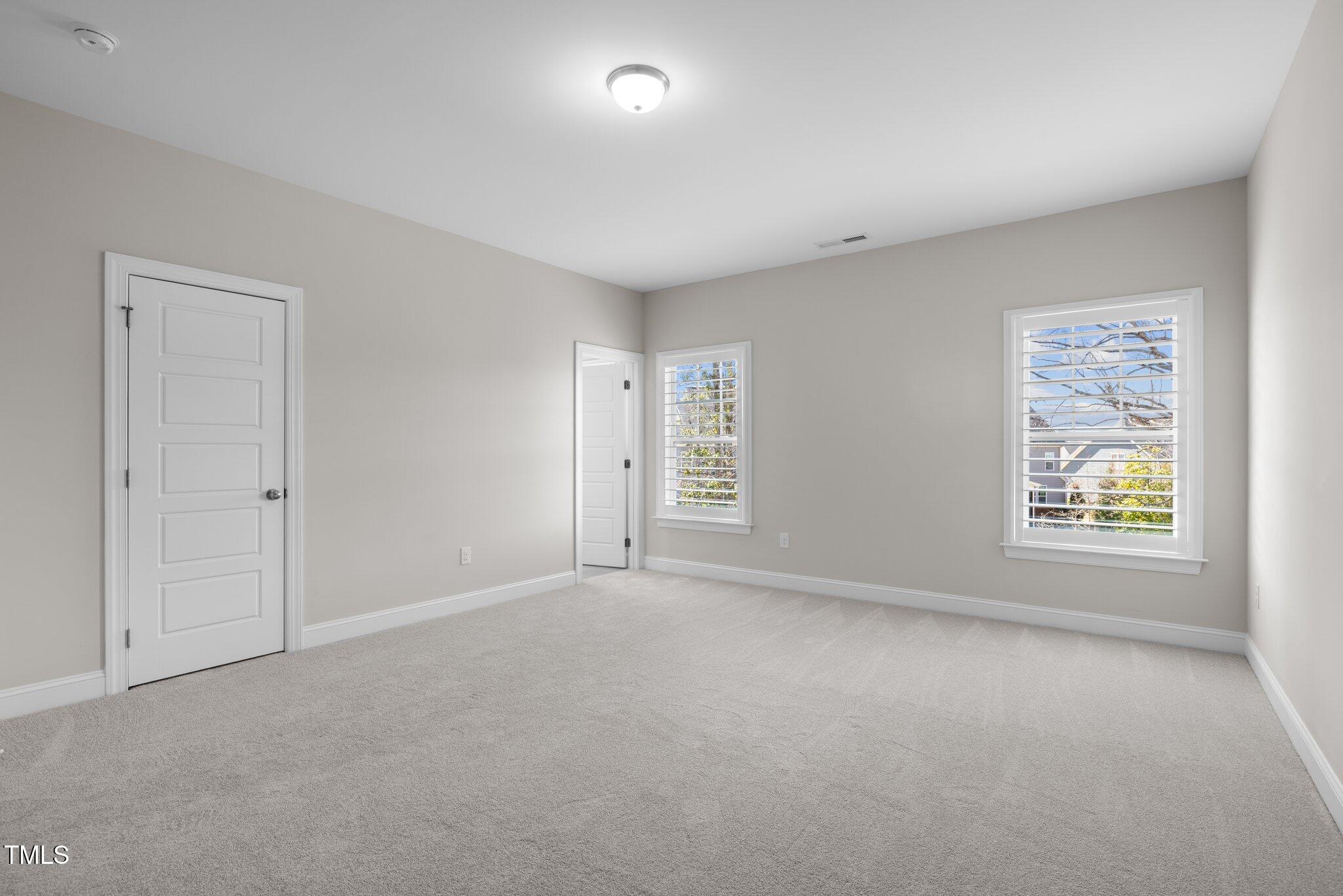 1013 Manchaca Loop Apex, NC 27539 - Photo 31 of 50 a view of an empty room with a window