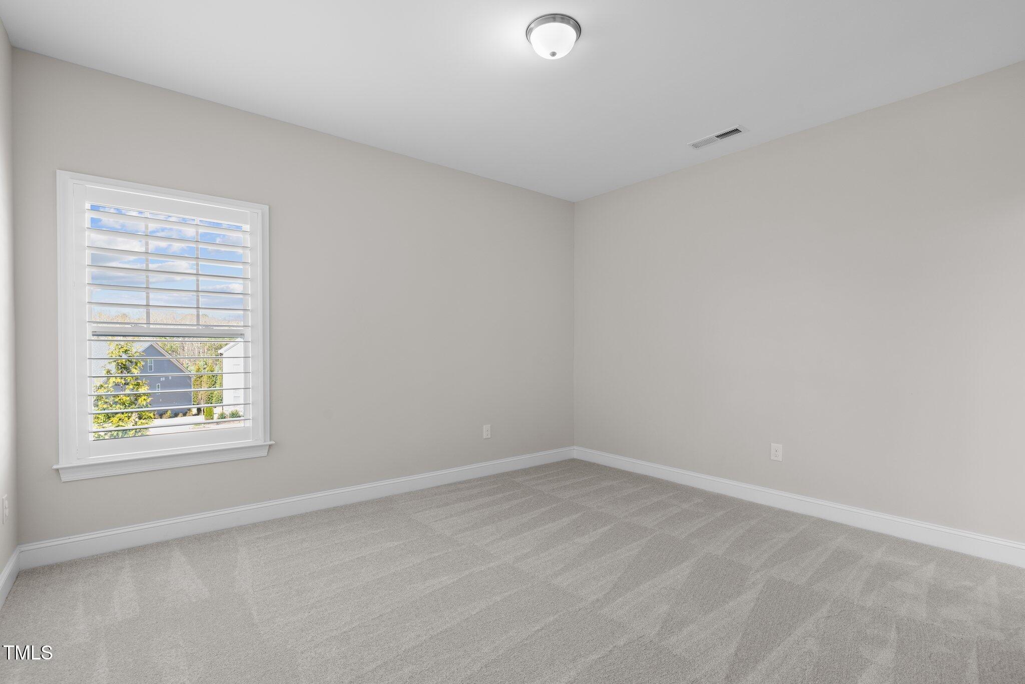 1013 Manchaca Loop Apex, NC 27539 - Photo 34 of 50 an empty room with a window