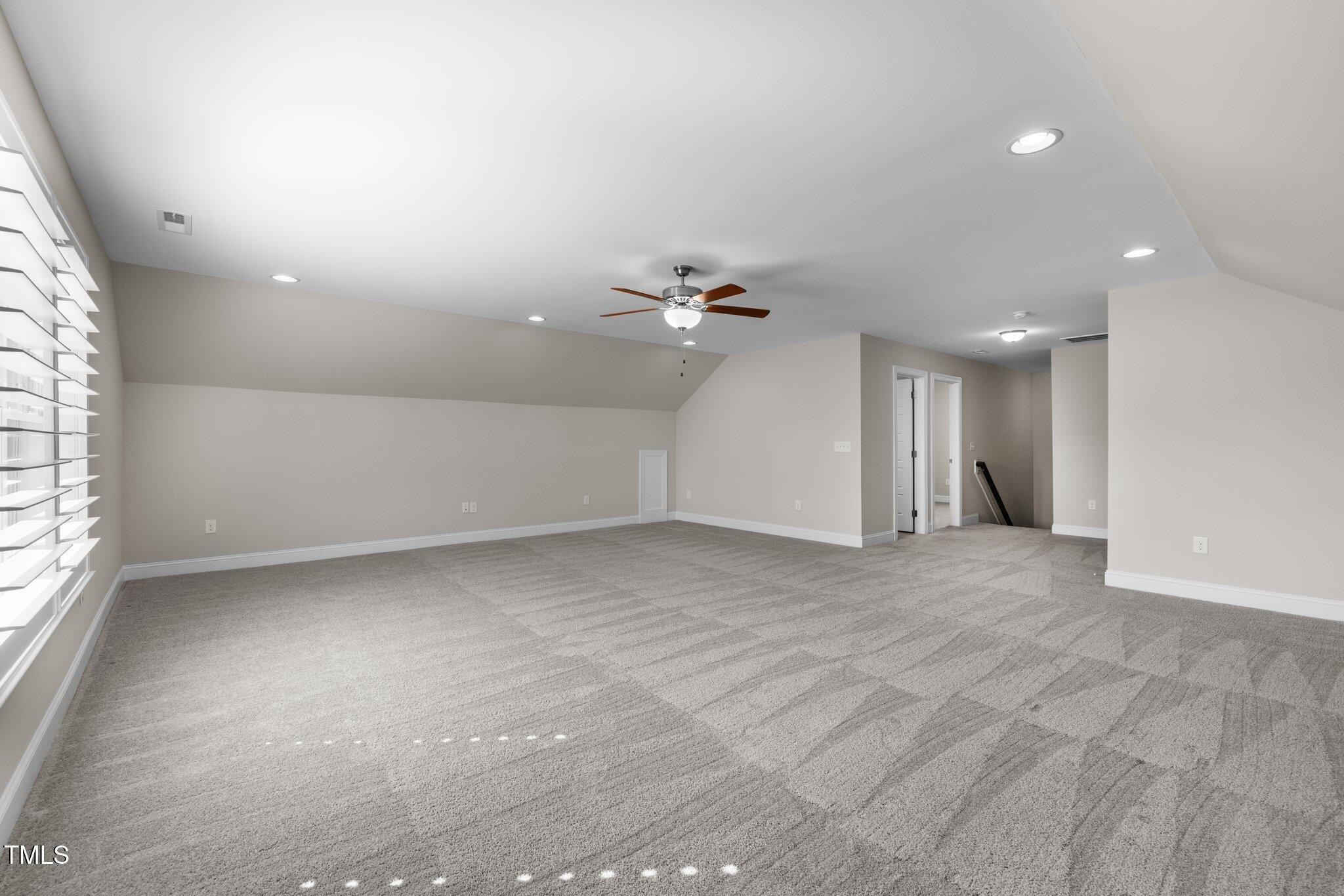 1013 Manchaca Loop Apex, NC 27539 - Photo 41 of 50 a view of a livingroom with a ceiling fan and window