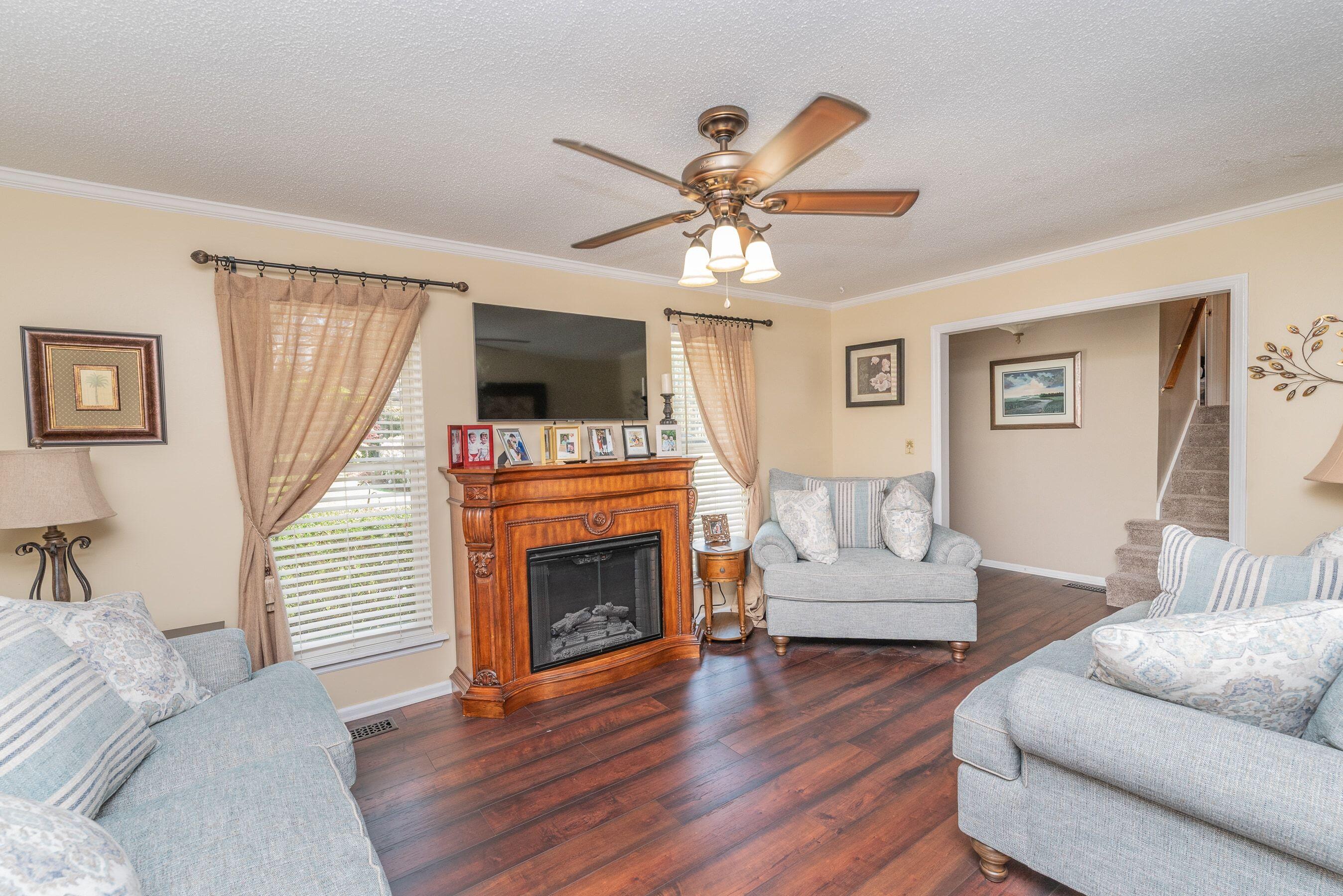 1117 Ridgemont Drive Aiken, SC 29803 - Photo 7 of 49 a living room with furniture a fireplace and a flat screen tv