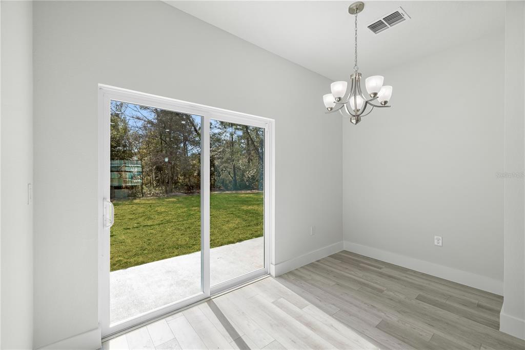 16054 Southwest 29th Court Road Ocala, FL 34473 - Photo 11 of 27 a view of empty room with wooden floor and fan