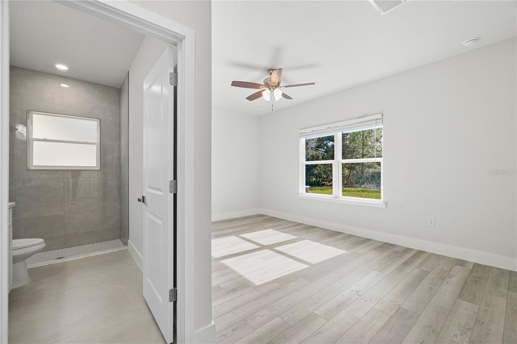 16054 Southwest 29th Court Road Ocala, FL 34473 - Photo 12 of 27 wooden floor in an empty room with a window