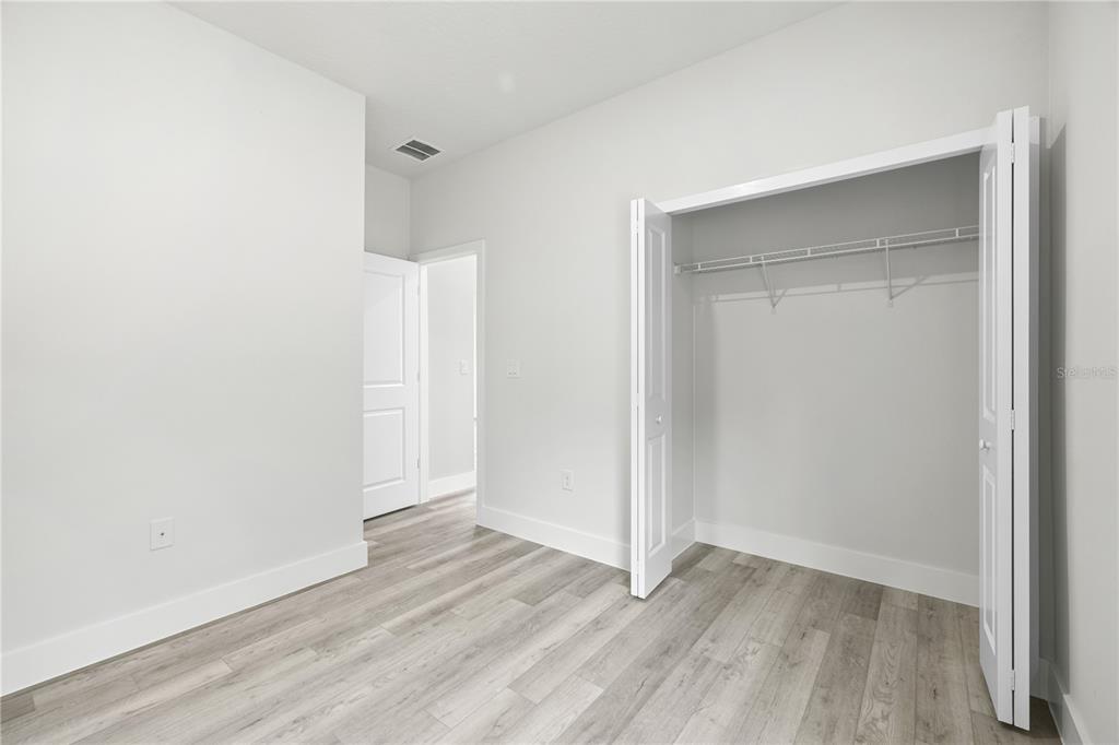 16054 Southwest 29th Court Road Ocala, FL 34473 - Photo 20 of 27 an empty room with wooden floor and closet