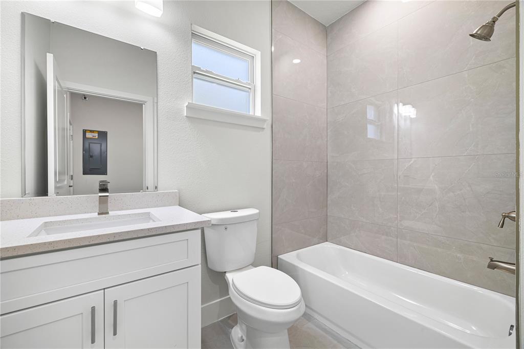 16054 Southwest 29th Court Road Ocala, FL 34473 - Photo 25 of 27 a bathroom with a sink a toilet and shower