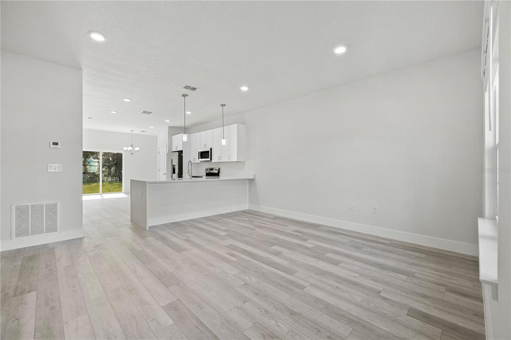 16054 Southwest 29th Court Road Ocala, FL 34473 - Photo 3 of 27 a view of kitchen with wooden floor and window