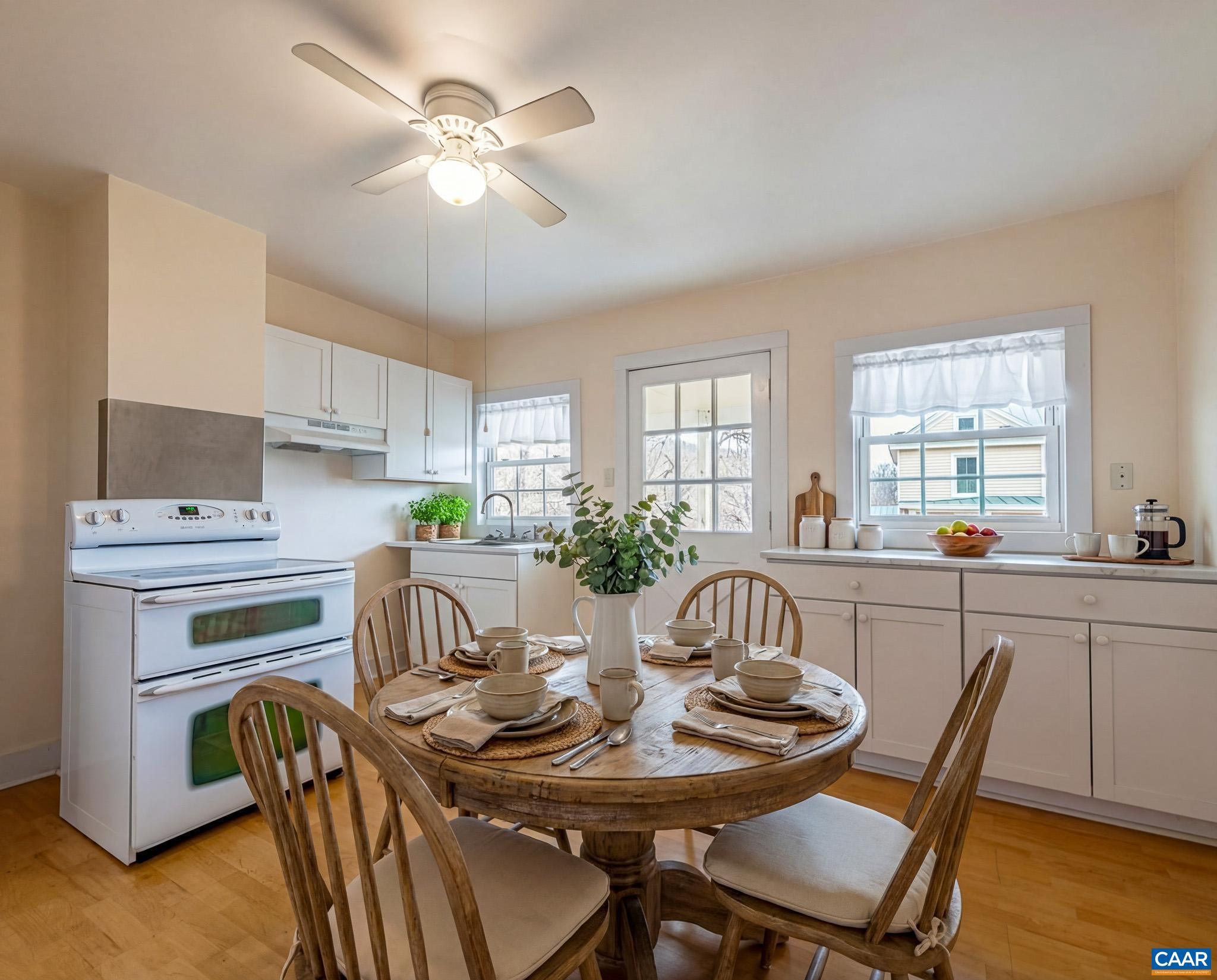 67 Lentz Lane Shipman, VA 22971 - Photo 6 of 31 a kitchen with stainless steel appliances kitchen island granite countertop a dining table chairs and a refrigerator