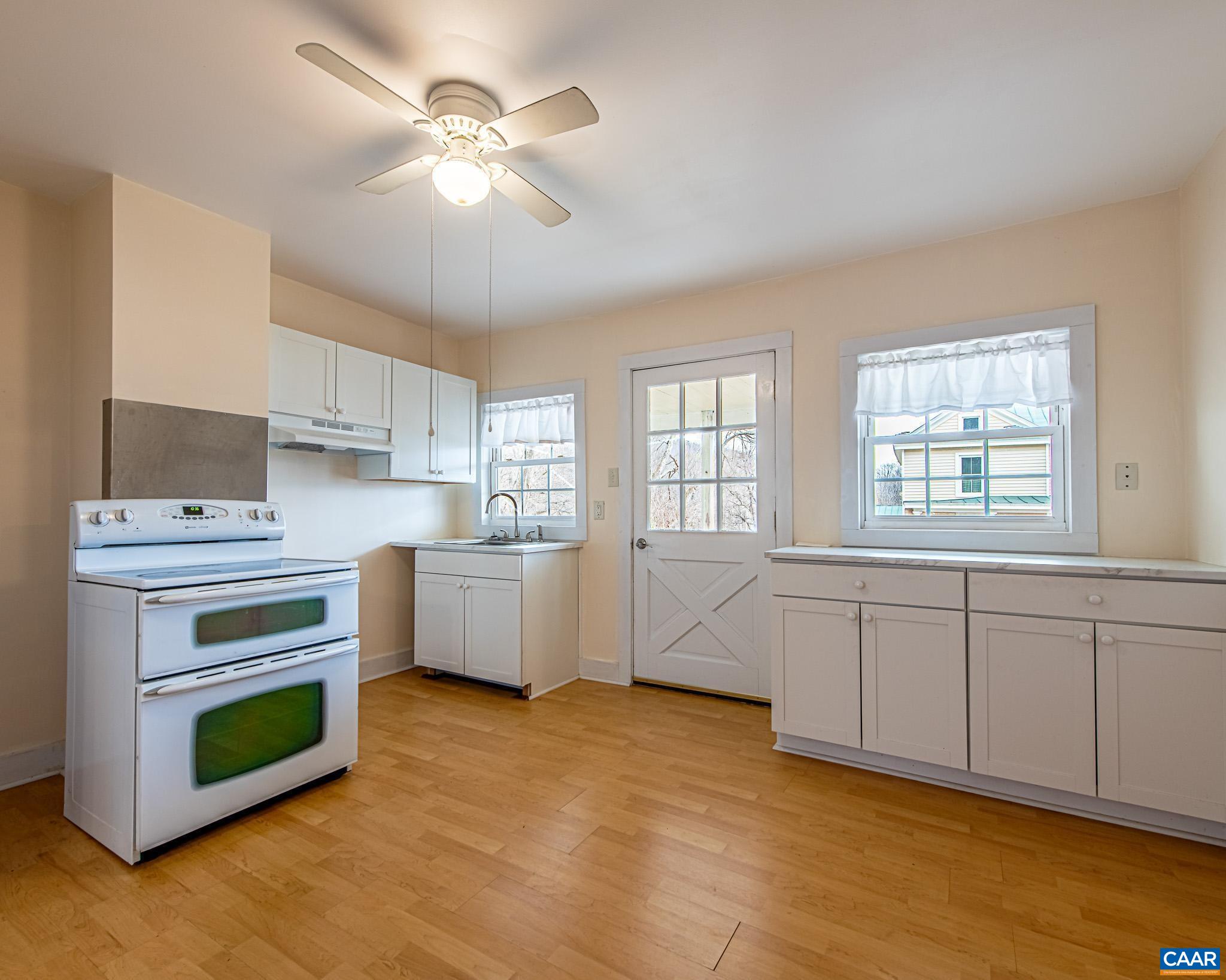 67 Lentz Lane Shipman, VA 22971 - Photo 7 of 31 a kitchen with a stove cabinets and wooden floor