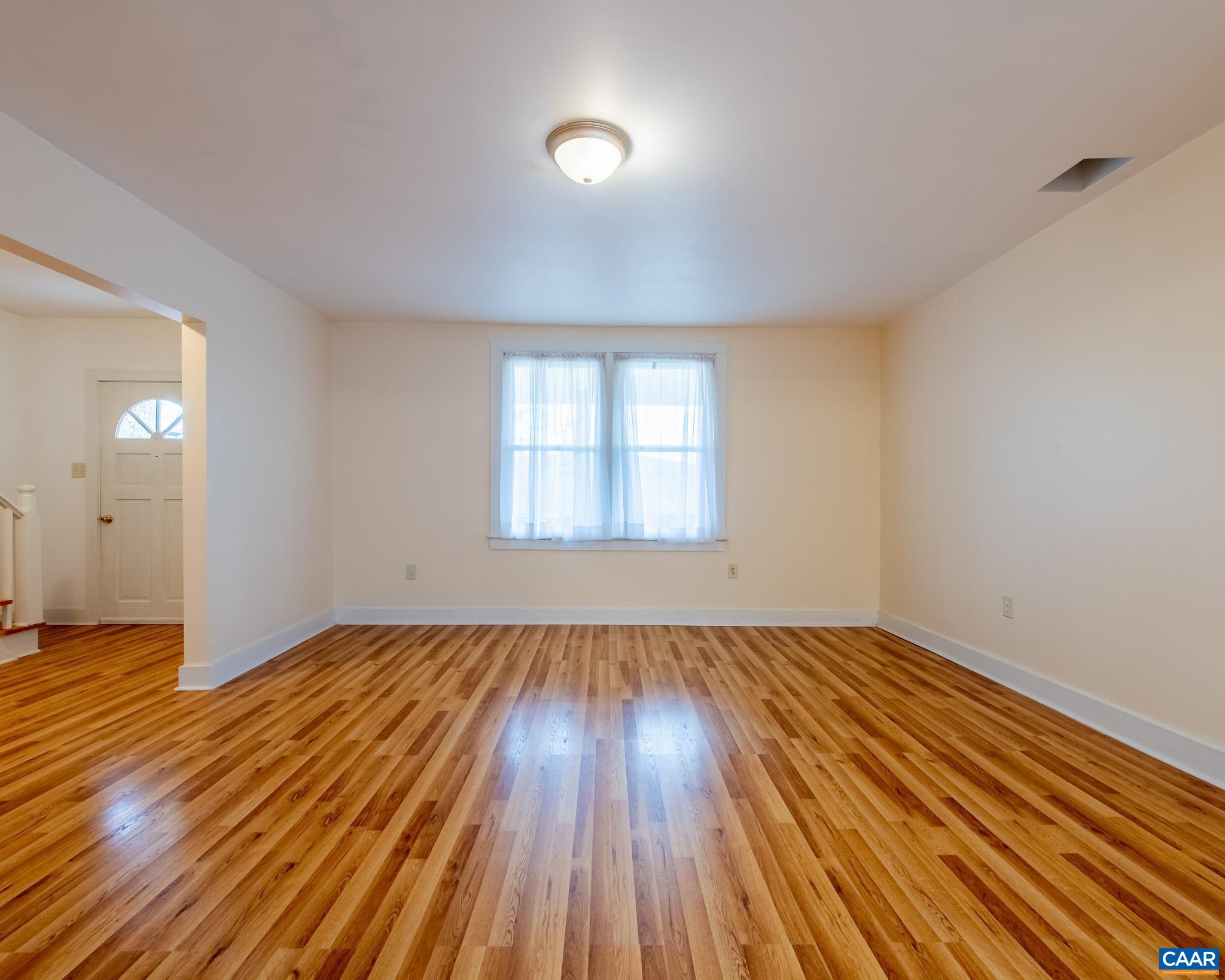 67 Lentz Lane Shipman, VA 22971 - Photo 9 of 31 an empty room with wooden floor and windows