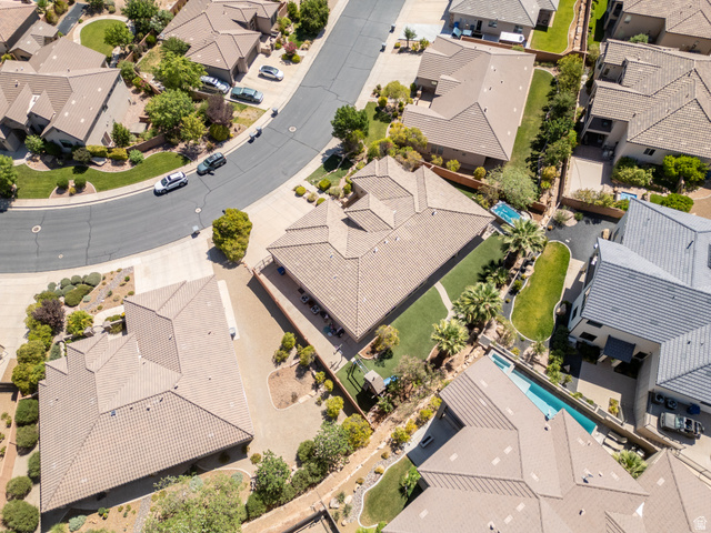 1257 West 2320 South St. George, UT 84770 - Photo 48 of 55 Aerial perspective showcasing the property's tile roof, expansive backyard with manicured lawn, established landscaping, and perimeter fencing