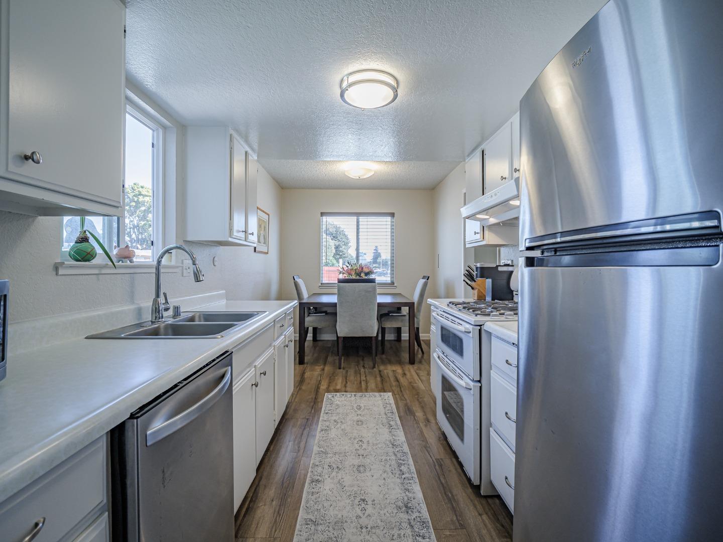 569 Cedar Drive Watsonville, CA 95076 - Photo 12 of 30 a kitchen with a sink and refrigerator
