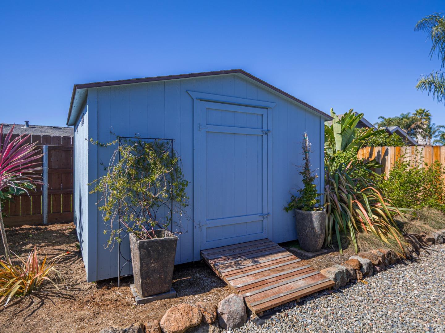 569 Cedar Drive Watsonville, CA 95076 - Photo 27 of 30 a wooden bench sitting in front of a house