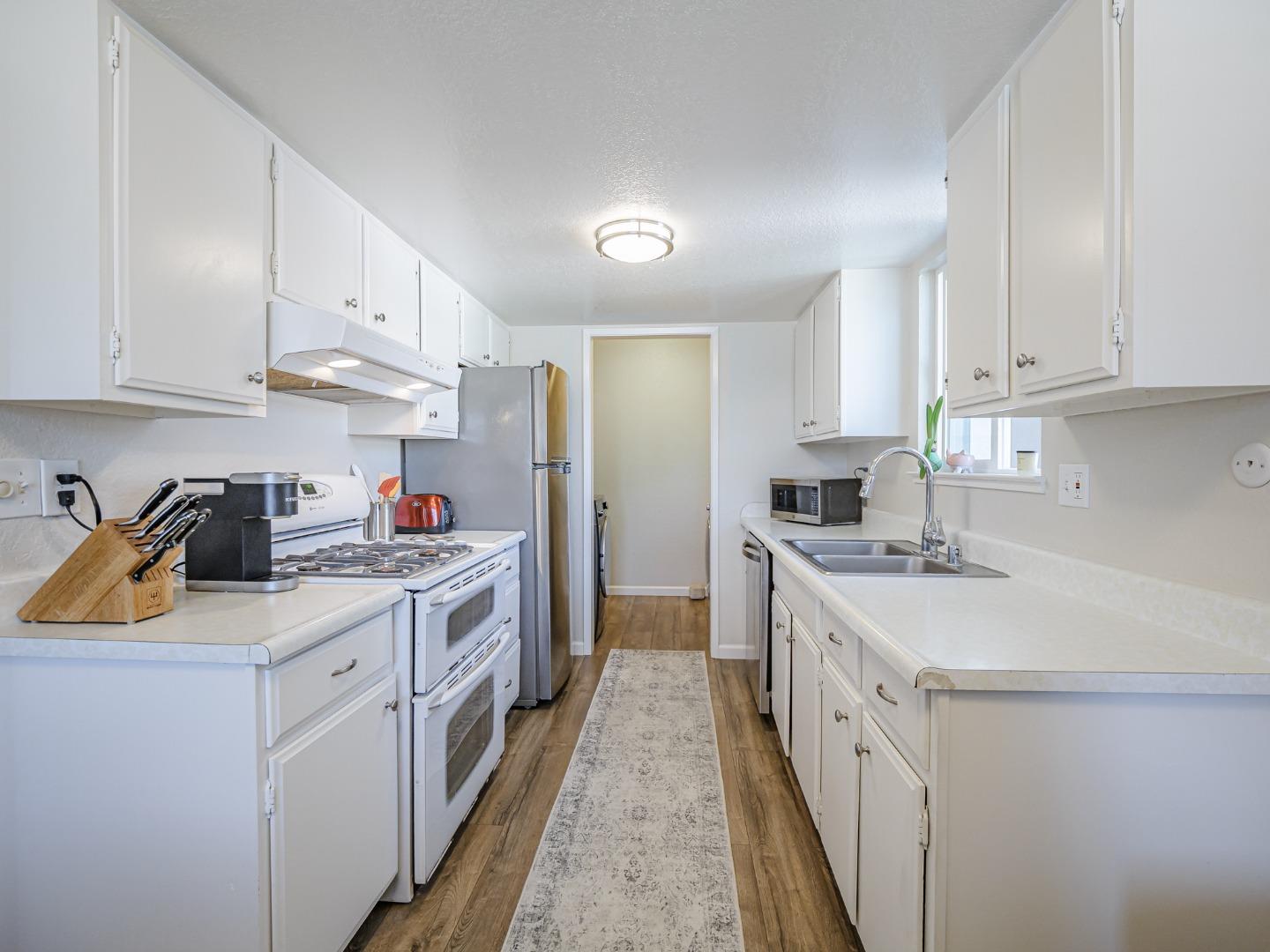 569 Cedar Drive Watsonville, CA 95076 - Photo 9 of 30 a kitchen with stainless steel appliances granite countertop a sink stove refrigerator and cabinets