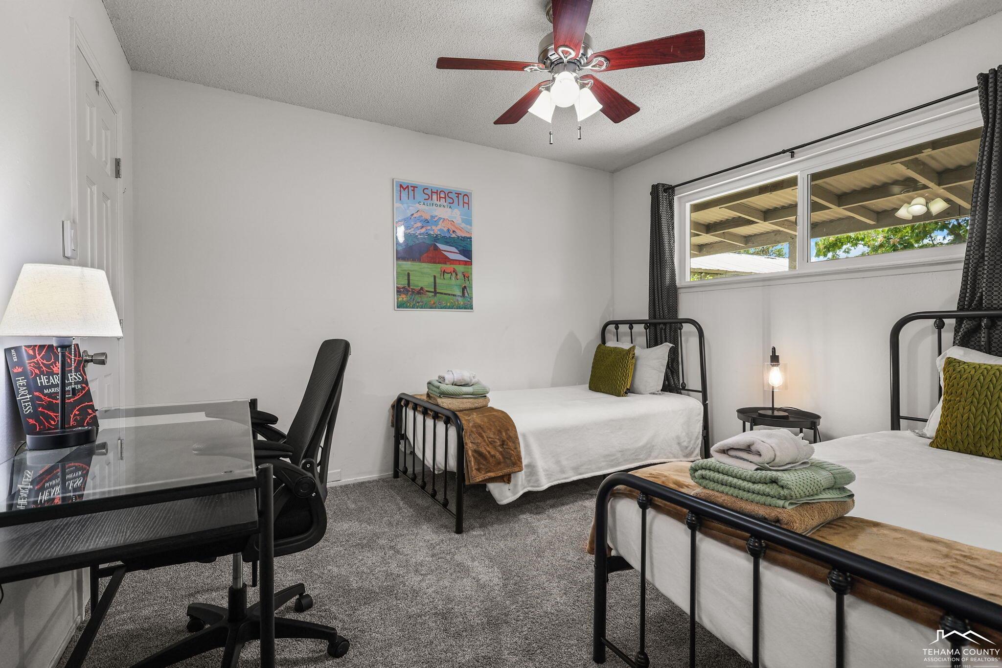 22275 Brent Road Red Bluff, CA 96080 - Photo 20 of 47 a bedroom with a bed a desk and chair with a large mirror