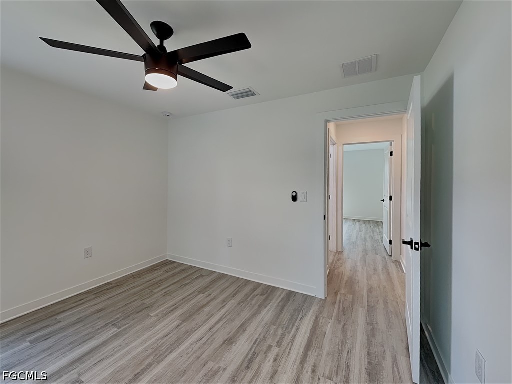 3201 23rd Street Southwest Lehigh Acres, FL 33976 - Photo 12 of 15 wooden floor in an empty room