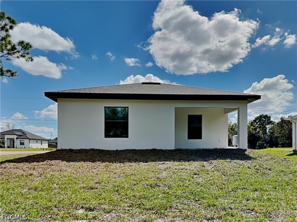 3201 23rd Street Southwest Lehigh Acres, FL 33976 - Photo 15 of 15 a view of a house with a yard