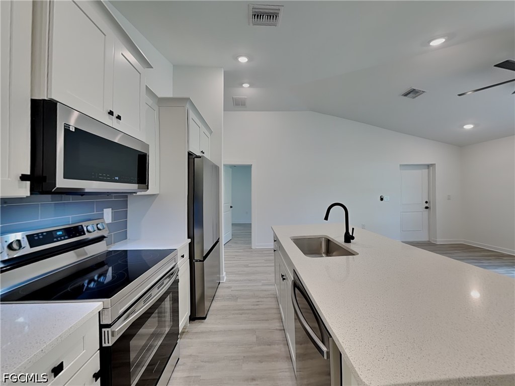 3201 23rd Street Southwest Lehigh Acres, FL 33976 - Photo 2 of 15 a kitchen with a sink stainless steel appliances and cabinets