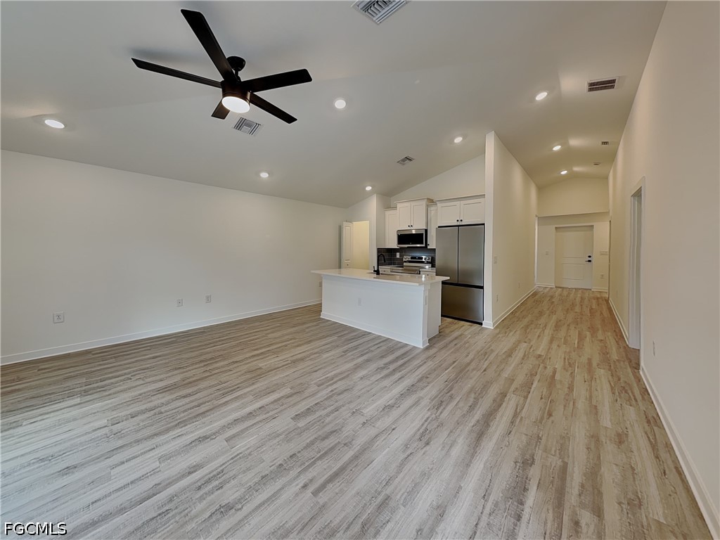 3201 23rd Street Southwest Lehigh Acres, FL 33976 - Photo 5 of 15 a view of a kitchen with a sink and wooden floor
