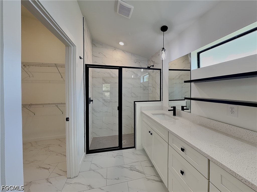 3201 23rd Street Southwest Lehigh Acres, FL 33976 - Photo 7 of 15 a bathroom with a double vanity sink mirror and shower