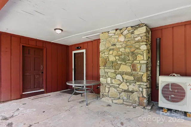 a view of an empty room with a fireplace and a window
