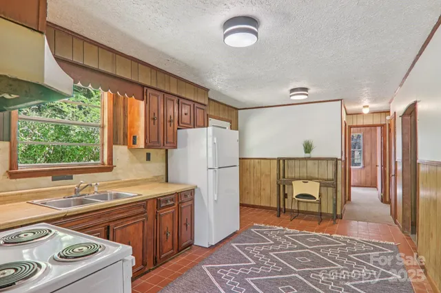 a kitchen with a stove a refrigerator and a sink